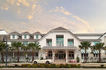 Olde Naples Hotel exterior on Broad Avenue South in Naples, Florida — white coastal building with palm trees and red bicycles out front